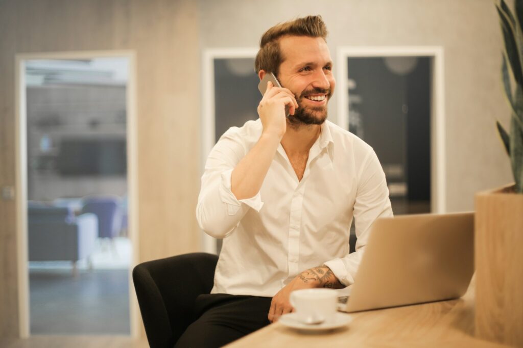 Small business owner on the phone weighing if an AI receptionist is worth it